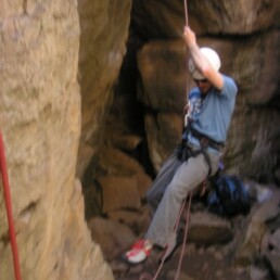 Matt Whitaker climbing a cliff with rope and harness in Los Conchas